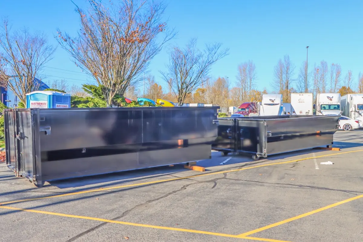 Professional dumpster rental service with roll-off container on residential driveway in Savannah